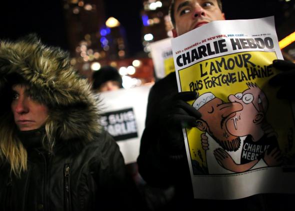 At a memorial in New York City’s Union Square, a Charlie Hebdo cover that reads “Love is stronger than hate.”