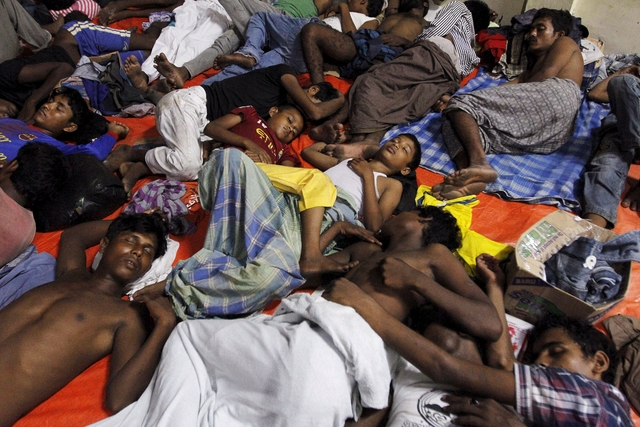 Migrants who arrived in Indonesia by boat rest inside a shelter in Kuala Langsa in Indonesia's Aceh Province May 16, 2015. Nearly 800 migrants were brought ashore in Indonesia on Friday, but other vessels crammed with them were sent back to sea despite a United Nations call to rescue thousands adrift in Southeast Asian waters with dwindling food and water. Thousands of Rohingya Muslims fleeing Myanmar and Bangladesh are stranded on boats as regional governments block them from landing. REUTERS/Roni Bintang