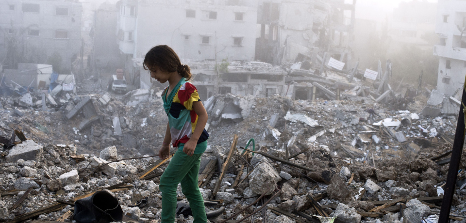 A Palestinian girl walks on the rubble strewn cieling of her family's home after she and other members of her family returned to their partially destroyed house early on August 27, 2014 in Gaza City's Shejaiya neighbourhood which was one of the hardest hit by the fighting. The skies over the Gaza Strip were calm as a long-term ceasefire between Israel and the Palestinians took hold after 50 days of the deadliest violence in a decade.  AFP PHOTO/ROBERTO SCHMIDT        (Photo credit should read ROBERTO SCHMIDT/AFP/Getty Images)