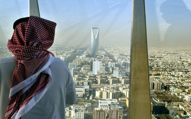 A+man+looks+at+central+Riyadh+from+the+Faisaliah+Tower,+Saudi+Arabia.