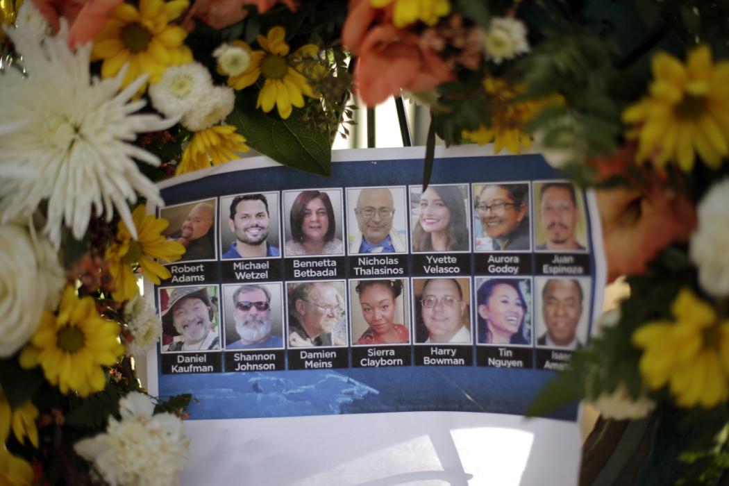Pictures of Wednesday's shooting victims are displayed at a makeshift memorial site Monday, Dec. 7, 2015 in San Bernardino, Calif. Thousands of employees of San Bernardino County are preparing to return to work Monday, five days after a county restaurant inspector and his wife opened fire on a gathering of his co-workers, killing 14 people and wounding 21.  (AP Photo/Jae C. Hong)