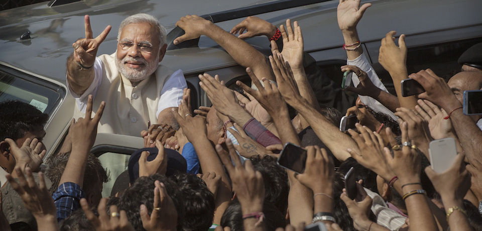 AHMEDABAD, INDIA - APRIL 30:  BJP leader Narendra Modi shows his inked finger to supporters as he leaves a polling station after voting on April 30, 2014 in Ahmedabad, India. India is in the midst of a nine phase election that began on April 7 and ends May 12.  (Photo by Kevin Frayer/Getty Images)