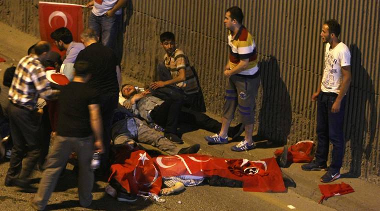 ATTENTION EDITORS - VISUAL COVERAGE OF SCENES OF INJURY OR DEATH - People react as bodies draped in Turkish flags are seen on the ground during an attempted coup in Ankara, Turkey July 16, 2016.  REUTERS/Stringer ATTENTION EDITORS - THIS IMAGE WAS PROVIDED BY A THIRD PARTY. EDITORIAL USE ONLY. NO RESALES. NO ARCHIVES. TURKEY OUT. NO COMMERCIAL OR EDITORIAL SALES IN TURKEY.       TEMPLATE OUT