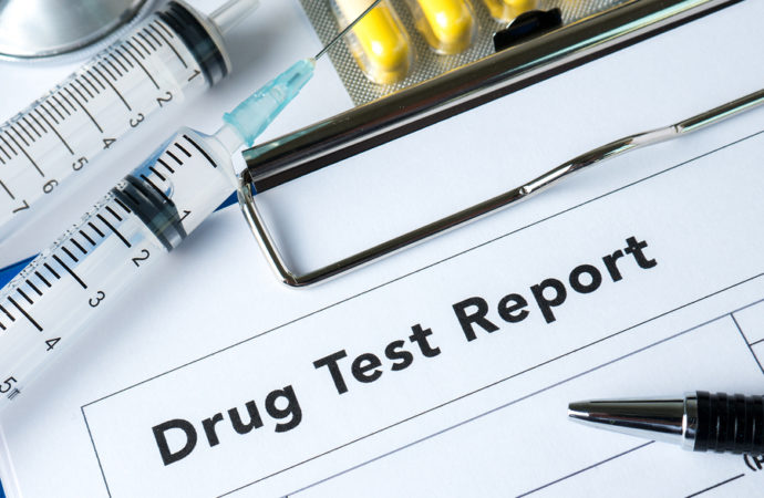 Syringe with glass vials and medications pills drug test report