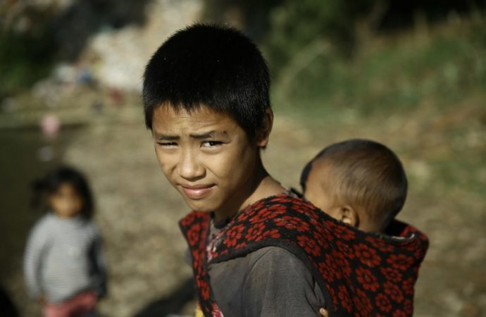 Refugees from Myanmar rest at a refugee camp near the China-Myanmar border in Wanding, in China's southwest Yunnan province on November 30, 2016. Thousands of refugees have fled into China in November due to fighting in northern Myanmar, and are being housed in temporary shelters along the border. Locals near the Chinese border in Myanmar's northern state of Shan said they were fleeing heavy fighting between the army and four armed ethnic groups, including the powerful Kachin Independence Army. / AFP PHOTO / STR / China OUT